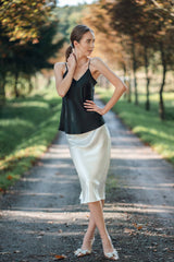 Model wearing black silk camisole top by Silk Closet. Outdoors